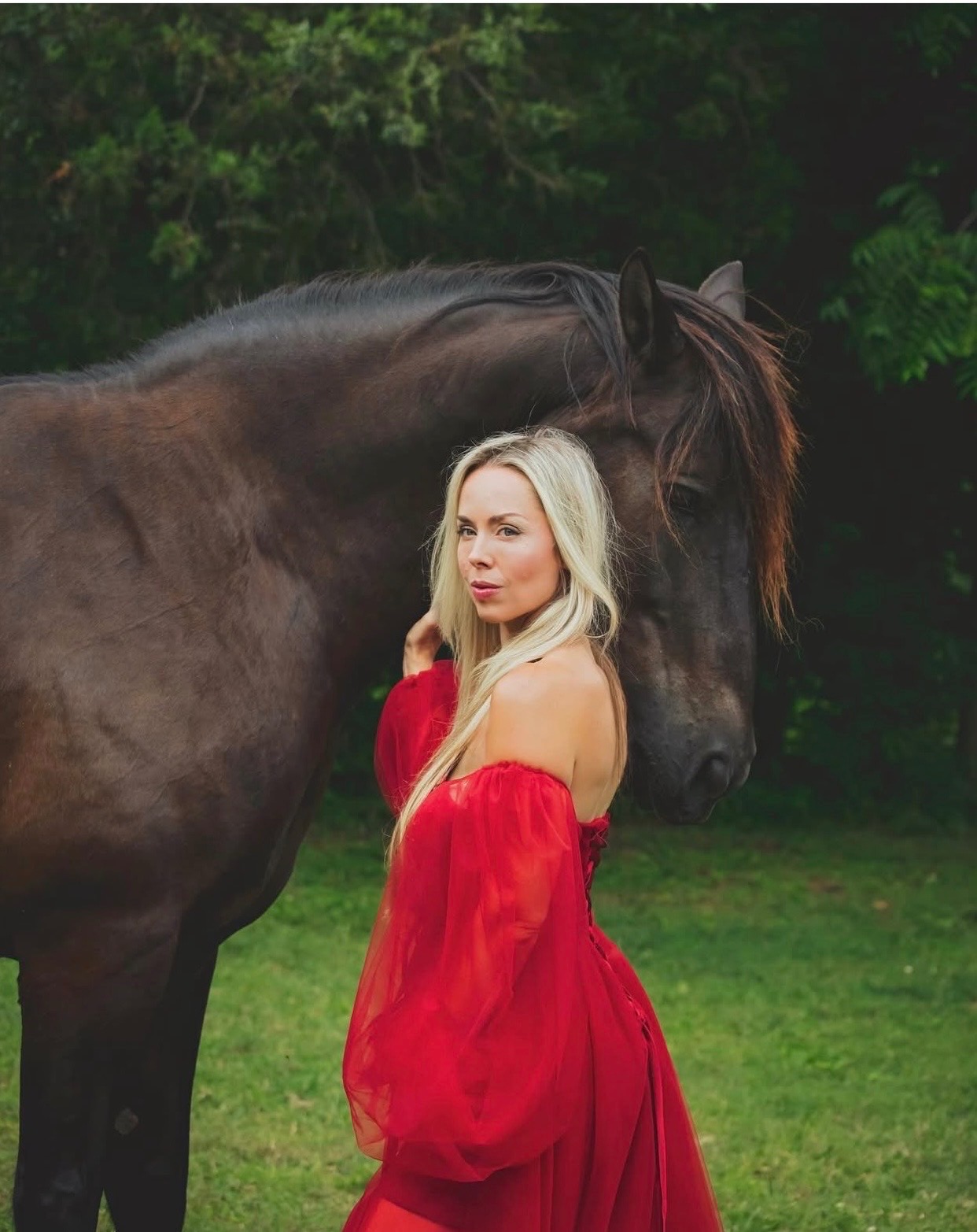 Moe Anato in red dress with black horse