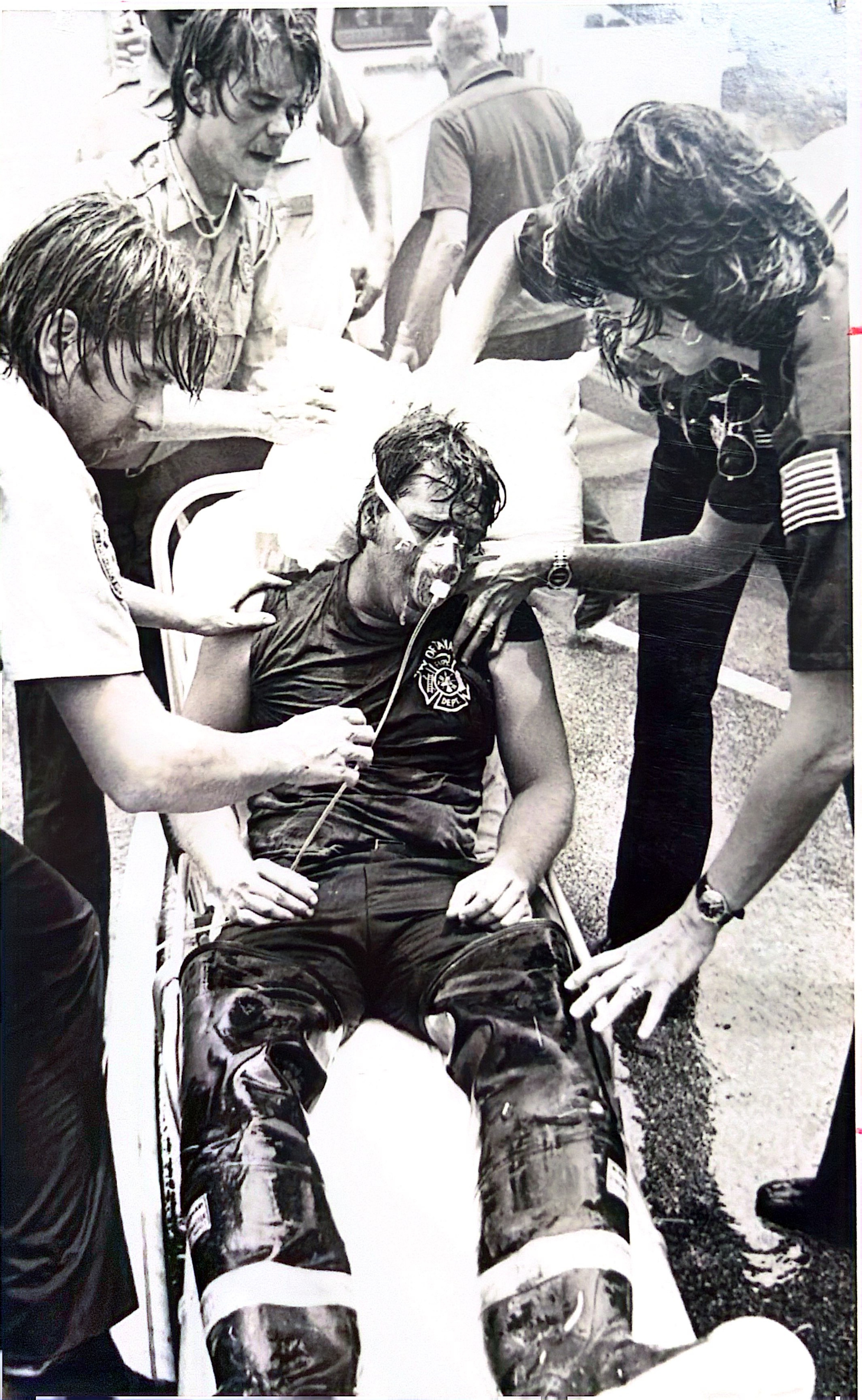 Pat Feher being treated after collapsing at the Sabal Palm fire — on oxygen, two medics attending