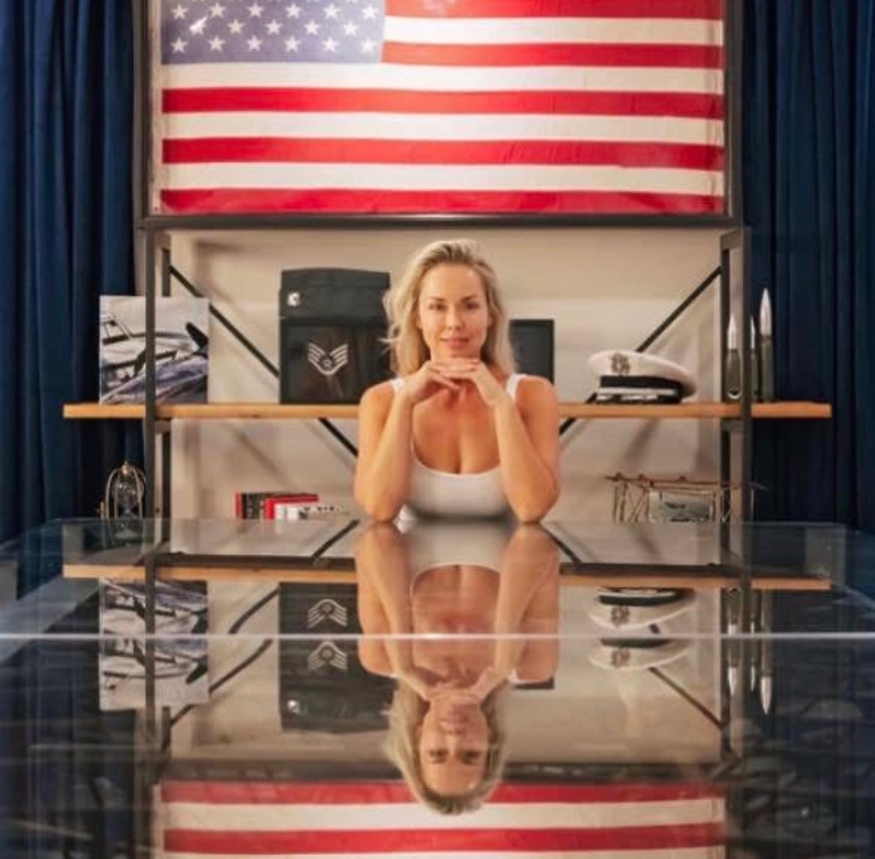 Moe Anato at High Flight — American flag, heritage shelf, reflected in the glass biplane wing table